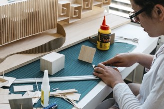 Woman architecture student working on models. Close up