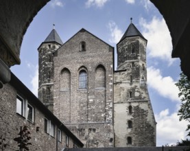 View from the cloister to the west façade of the Romanesque Basilica of St Mary in the Capitol