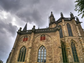 Gothic brick church with high windows and a dramatic, cloudy sky, Xanten, North Rhine-Westphalia,