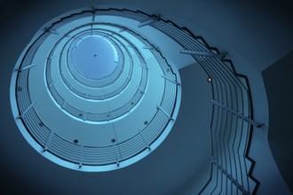 Futuristic spiral staircase in blue light with metallic railings, Free and Hanseatic City of