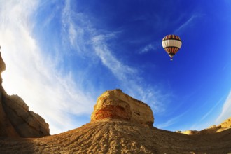 Huge balloon above ancient mountains of the Dead Sea. A sunset