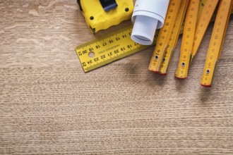 Construction plans and instruments of measurement on oaken wooden board maintenance concept