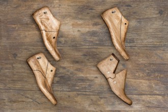 Shoe lasts hanging on a wooden wall