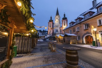 Advent atmosphere, street illuminated for Christmas, facade of the basilica behind, blue hour in