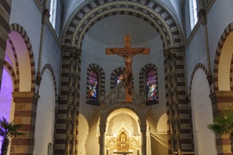 Romanesque church interior with wooden cross, colourful windows and pastoral atmosphere, ankum,