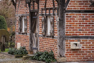 Historic half-timbered house with wooden doors and small windows, weseke, münsterland, germany