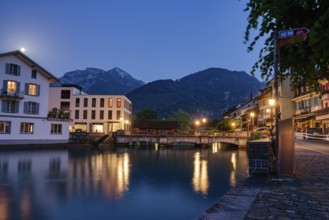 Serene village view at night with a bridge and river reflections, city, vilage, cityscapes,