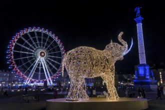 Schlossplatz decorated for Christmas in the evening, with illuminated figure of an elephant and in