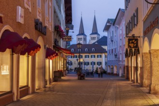 Pedestrian zone and collegiate church of St Peter and St John the Baptist in the old town at dusk,