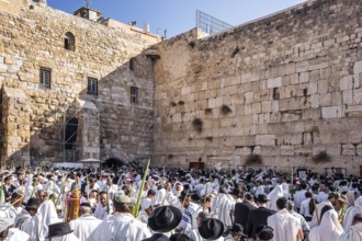 Jerusalem. Jews praying wrapped in festive white Talit. Exciting ceremony at the Western Wall of