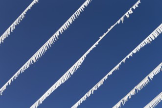 The photo shows white paper garlands with a blue sky on Majorca