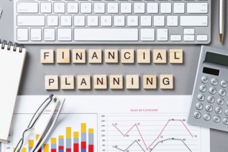 Financial planning concept with letters on cubes. Still life of office workplace. Flat lay grey