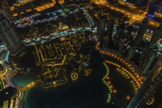 Dubai downtown night scene with city lights. Top view from above