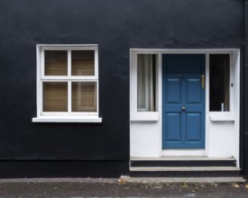 Traditional colourful house facade with closed window and door i. Kinsale Ireland