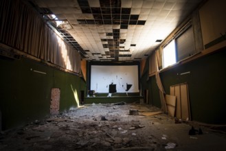 Abandoned and damaged interior of a stage theatre with bright light entering the building, Nicosia