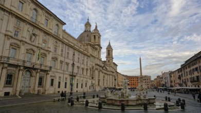 Piazza Navona with its striking church and obelisk under a partly cloudy sky, Rome, Lazio, Italy,