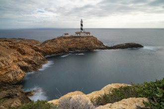 Long exposure view of the Cap de Cala Figuera lighthouse under an overcast sky