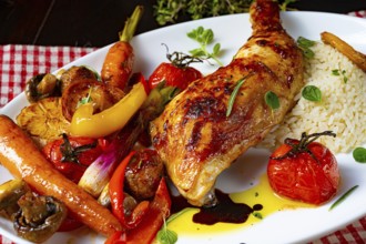Rustic fried chicken legs with assorted vegetables and rice