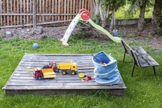 Untidy playground with sandpit in the garden