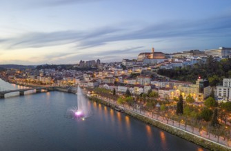 Coimbra drone aerial city view at sunset with colorful fountain in Mondego river and beautiful