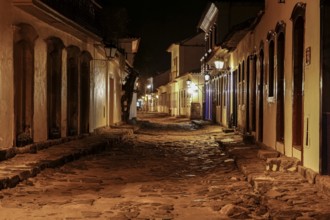 Atmospheric night view of illuminated street and buildings in historical center of Paraty, Brazil,