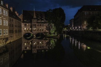 Neurenberg, Bavaria, Germany, 07 26 2018: Tourists viewing old town, reflected in the water at