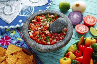 Pico de Gallo sauce from Mexico with tomato cilantro and onion in molcajete