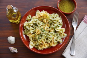 Farfalle pasta with Pesto on wooden table