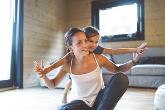 Young family with a girl, spending time at home on the weekends. Loving family resting on the