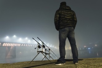 Night Fishing Urban Edition. Fisherman in Foggy night. Night Fishing, Carp Rods, Night reflection.