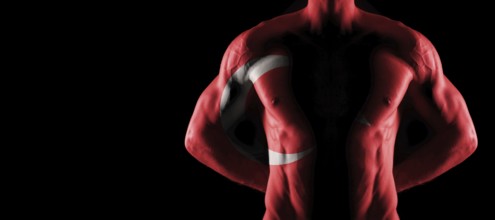 Turkey flag on muscled male torso with abs, black background