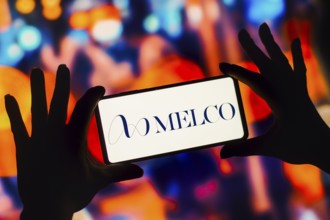 In this photo illustration, the Melco Resorts and Entertainment Limited logo is displayed on a