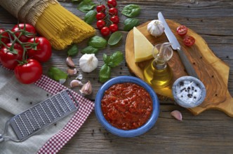 Italian Spaghetti pasta food with cheese tomato garlic basil on wood