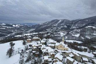 Aerial view of vezzolacca, a small village in the ligurian apennines, covered by snow in winter
