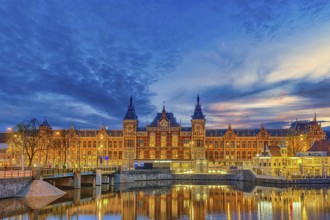 Amsterdam Netherlands, night city skyline at Amsterdam Central Station