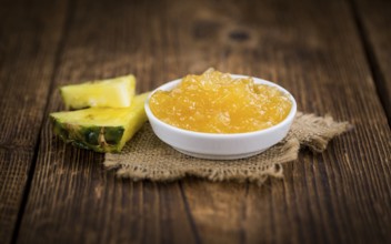 Fresh made Pineapple Jam on a vintage background as detailed close-up shot
