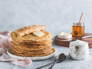 Stack of traditional russian pancakes blini on gray background with copy space. Homemade russian