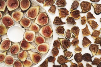 Sliced fresh and dried figs lie on the table. Top view.