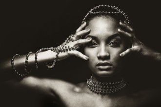 Upscale Indian woman wearing chain jewellery and beautiful makeup. Black and white photo.