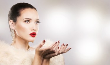 Upscale woman wearing gold jewellery and red lipstick on light background, Toronto, Canada, North