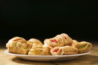 Cookies from puff pastry with coloured jam