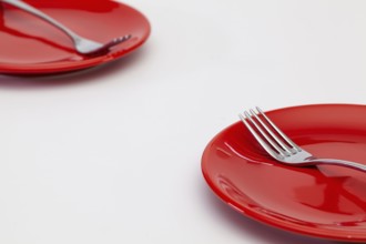 Red plates on the white wooden table.Top view. Flat Lay Image