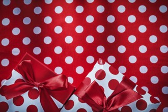 Decorated presents on polka-dot red table cloth holidays concept