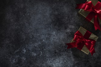 Two Golden Gift Boxes On Dark Background With Copy Space