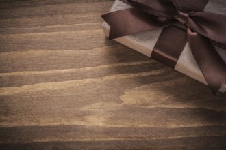 Packed present on vintage wooden board copy space holidays concept