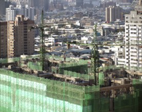 Construction site with two cranes seen from above