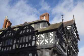 Typical large old half timbered tudor building in Chester city centre with overhanging bays and