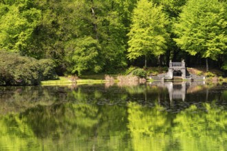 Lake with artificial waterfall in the royal palace park Kroondomein in the Dutch city Apeldoorn