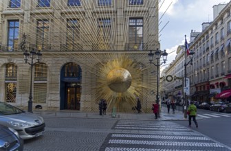 PARIS, FRANCE, DECEMBER 17, 2017: Sculpture on the facade of the building, the sun emits rays.