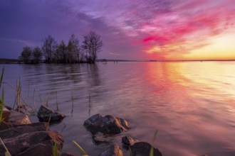 Beautiful romantic colourful sunset over a calm lake